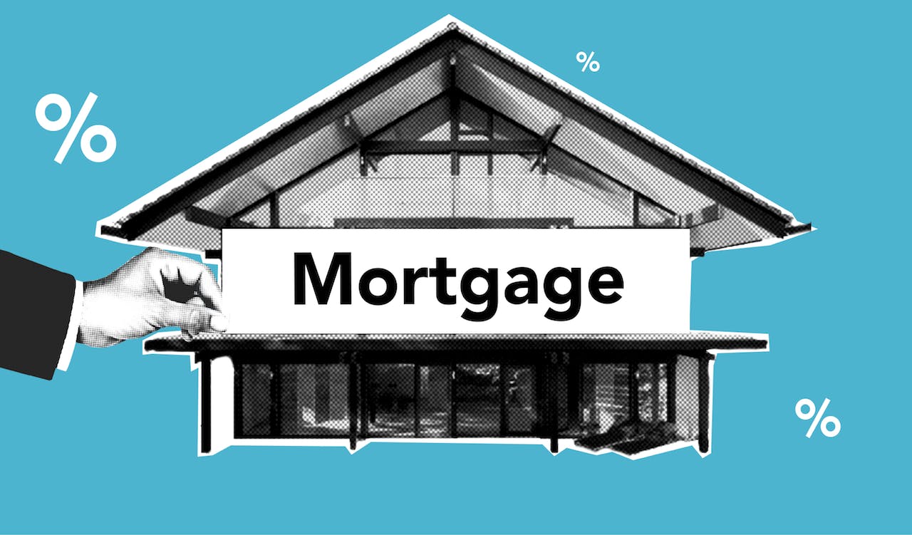 Hand holding label with word “Mortgage” with house in background. 
