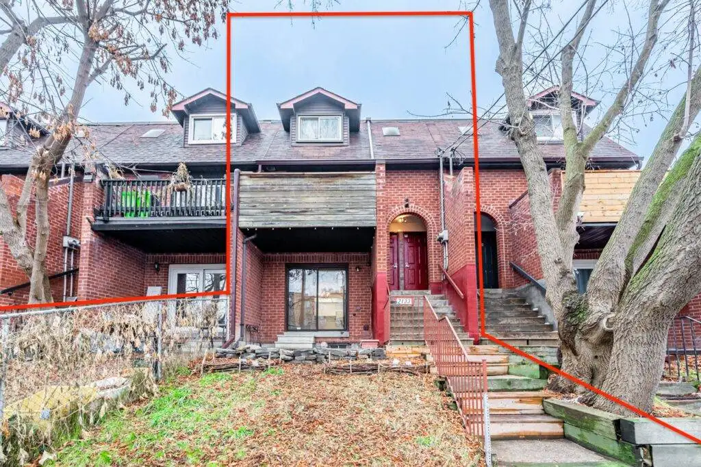 Front of 2133 Dufferin St, a 3-storey red-brick triplex.