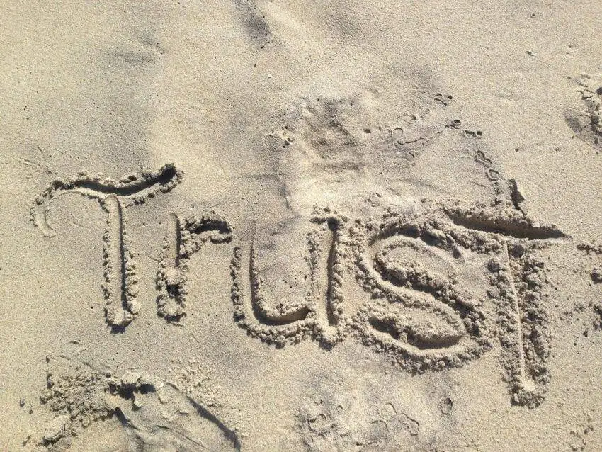 Word “Trust” written in sand to show T in TRESA.
