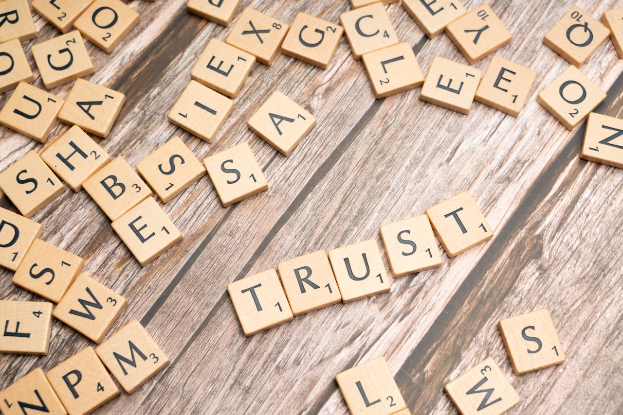 Scrabble tiles spelling word "Trust."