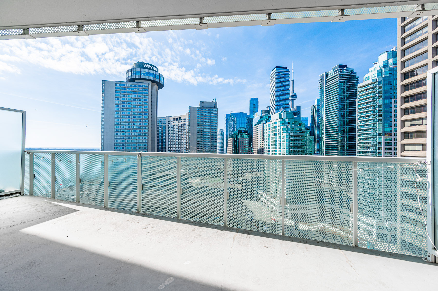 Balcony with glazed dividers and grilled front panels – 15 Queens Quay E Unit 1605.