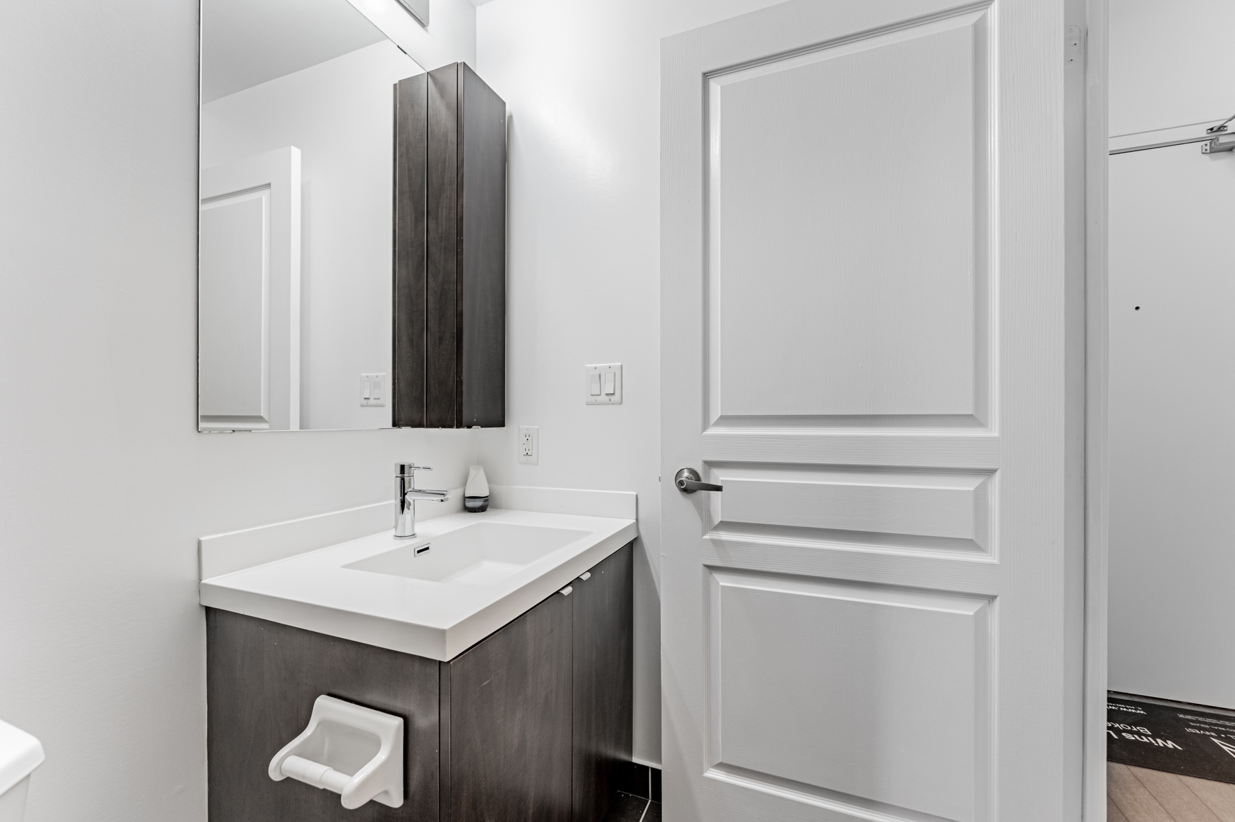 Condo bathroom vanity, sink and medicine cabinet.