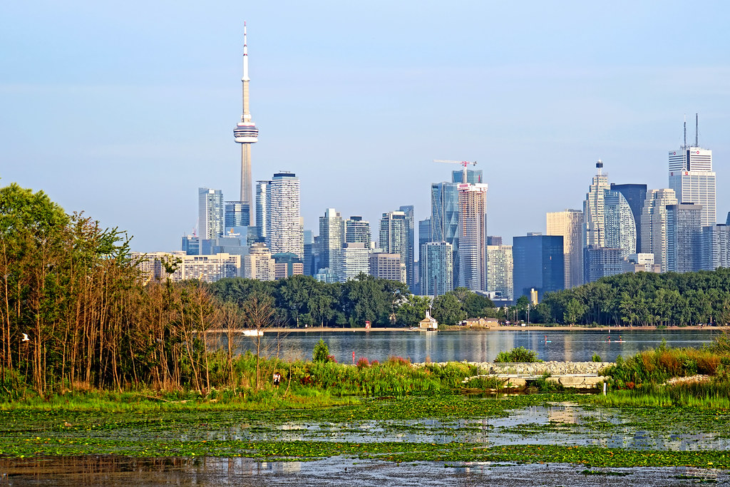 Toronto skyline with view of water and trees.
