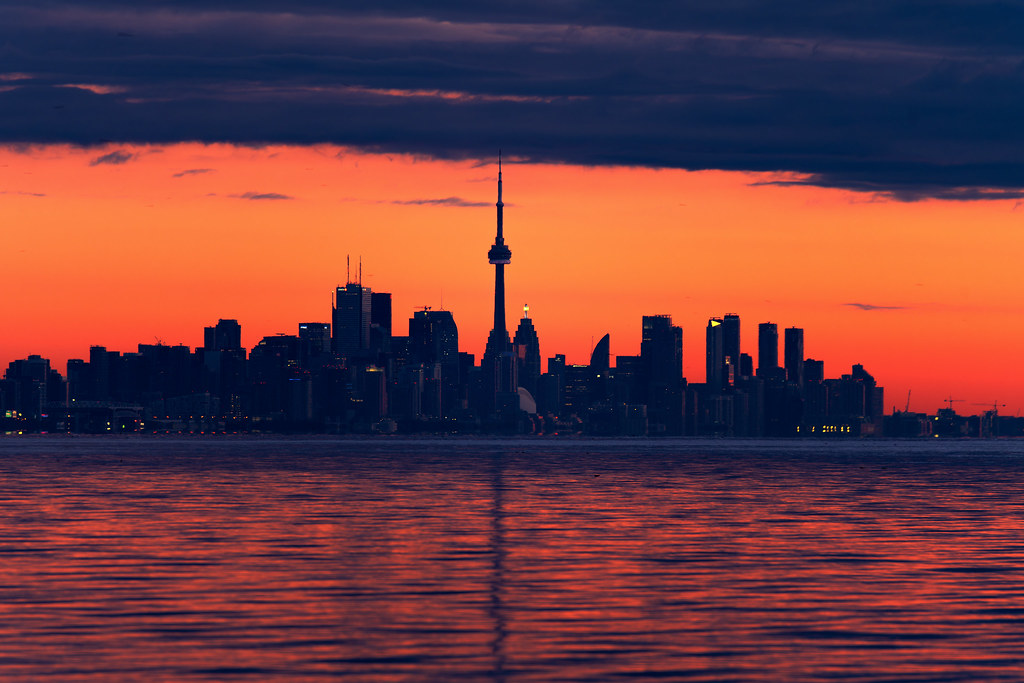 Toronto skyline at dusk from Lake Ontario to conclude March 2024 market report.