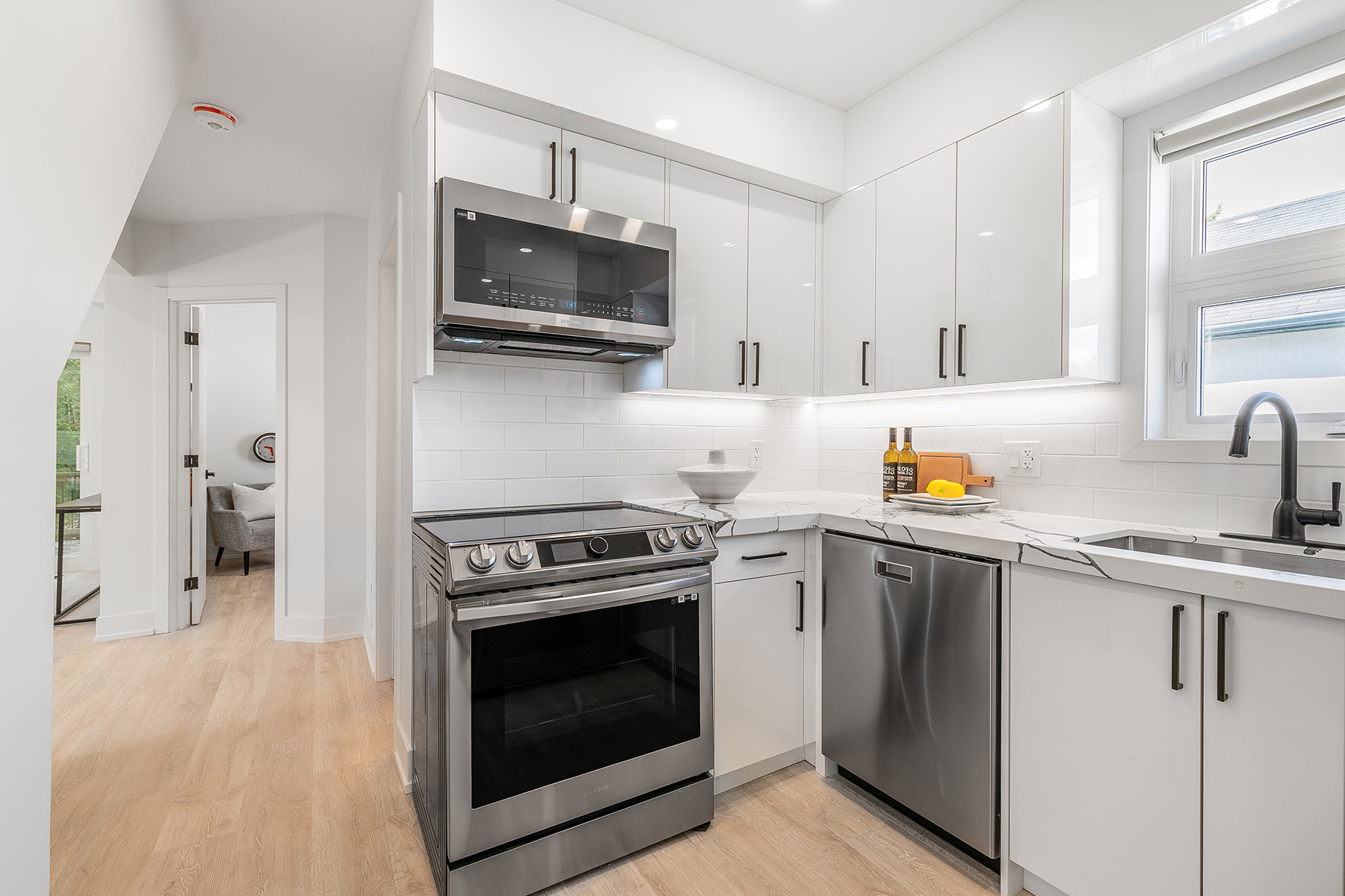 54 Huntington Avenue kitchen with glossy cabinets, quartz counters and ceramic back-splash.