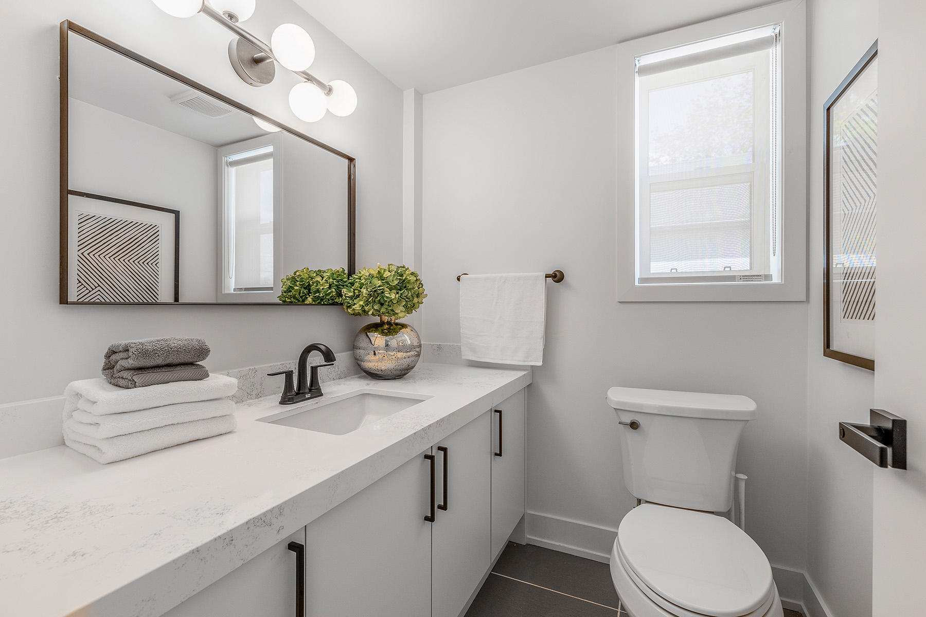 54 Huntington Avenue powder room with white marble counters and cabinets.