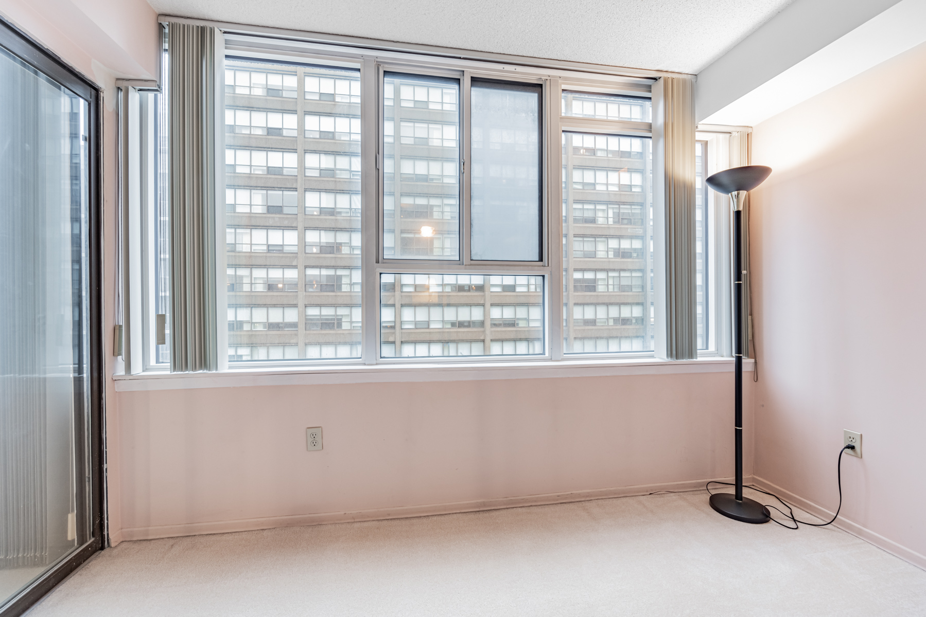 Primary bedroom den with pink walls and large windows – 45 Carlton St Unit 1405.