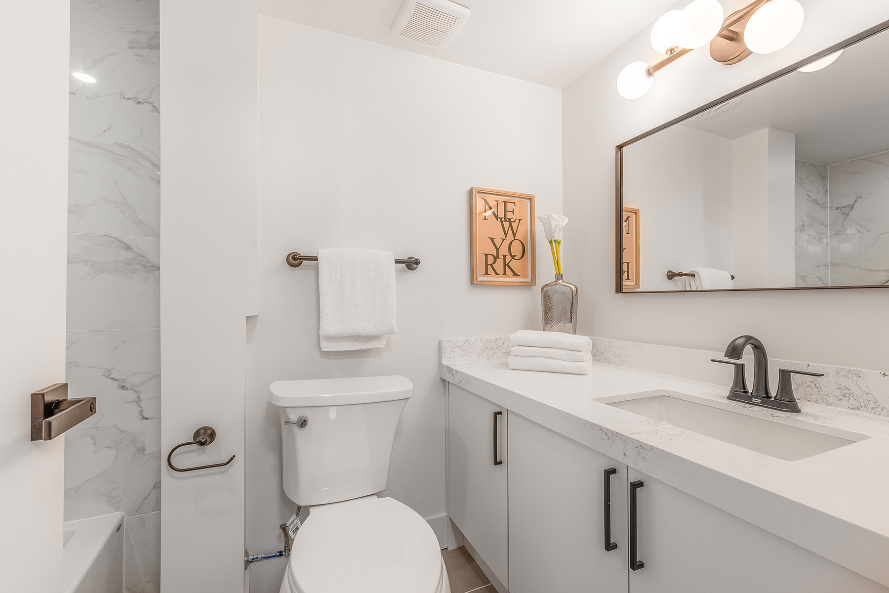 4-piece bathroom white gray-white tiles, counters, tub, storage cabinets – 54 Huntington Avenue.