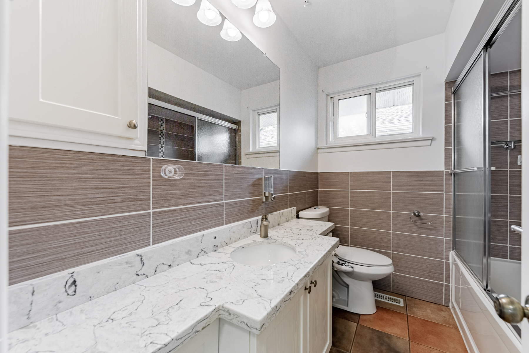 36 Earlton Rd 4-piece bathroom with long vanity, ceramic floors, and wide mirror.