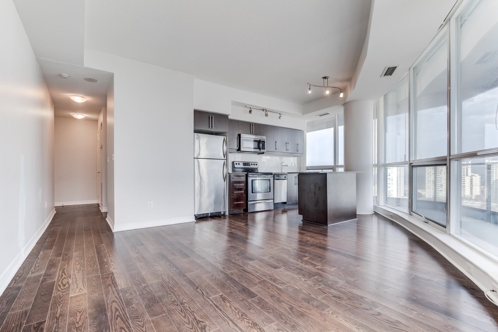 Large condo living, dining and kitchen areas.