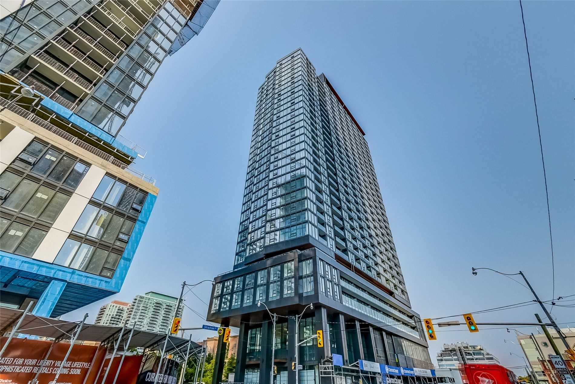 Zen West Condos, tall building with dark gray lines and blue glass facade.