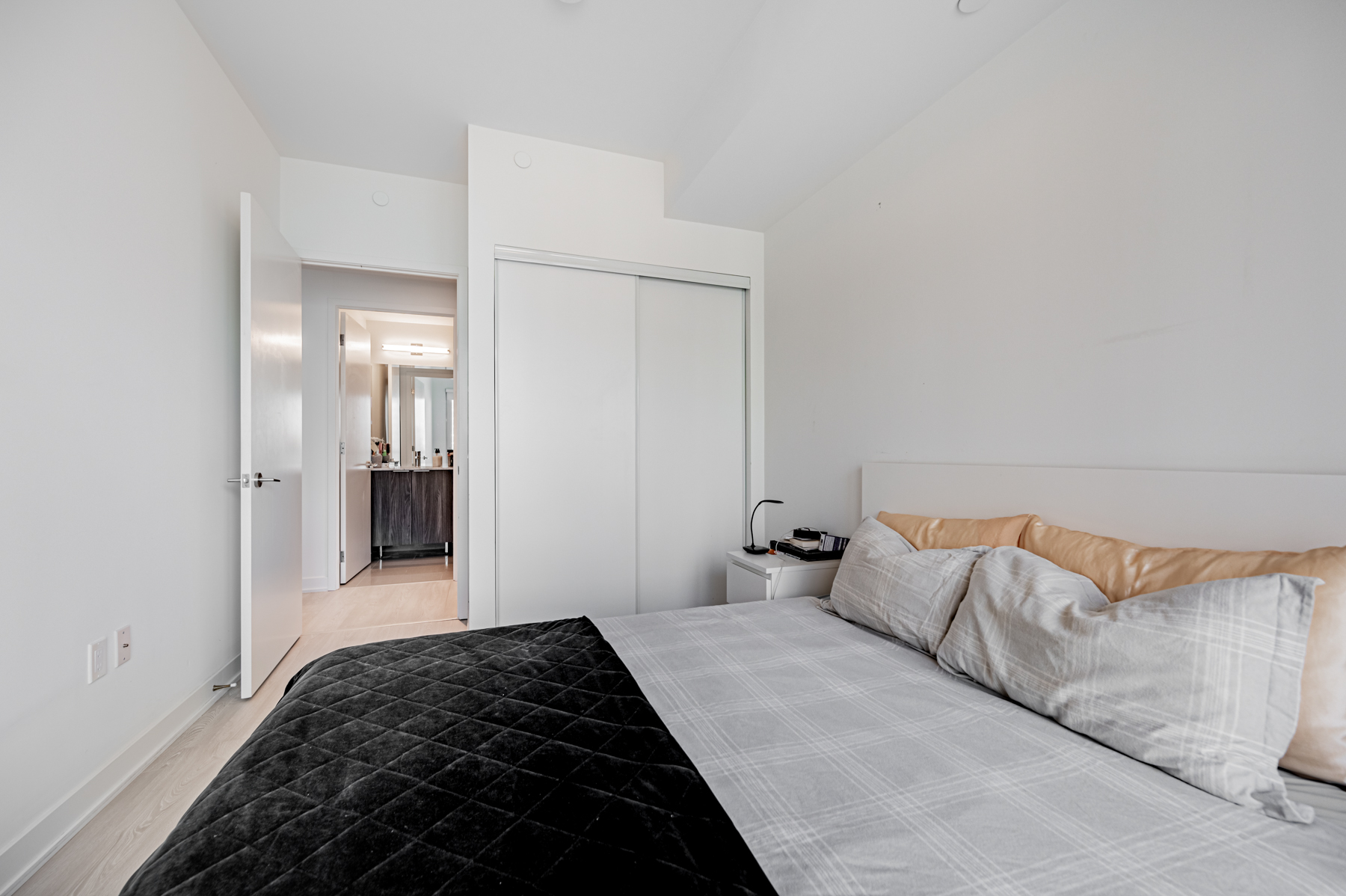 Condo bedroom with double door closet.