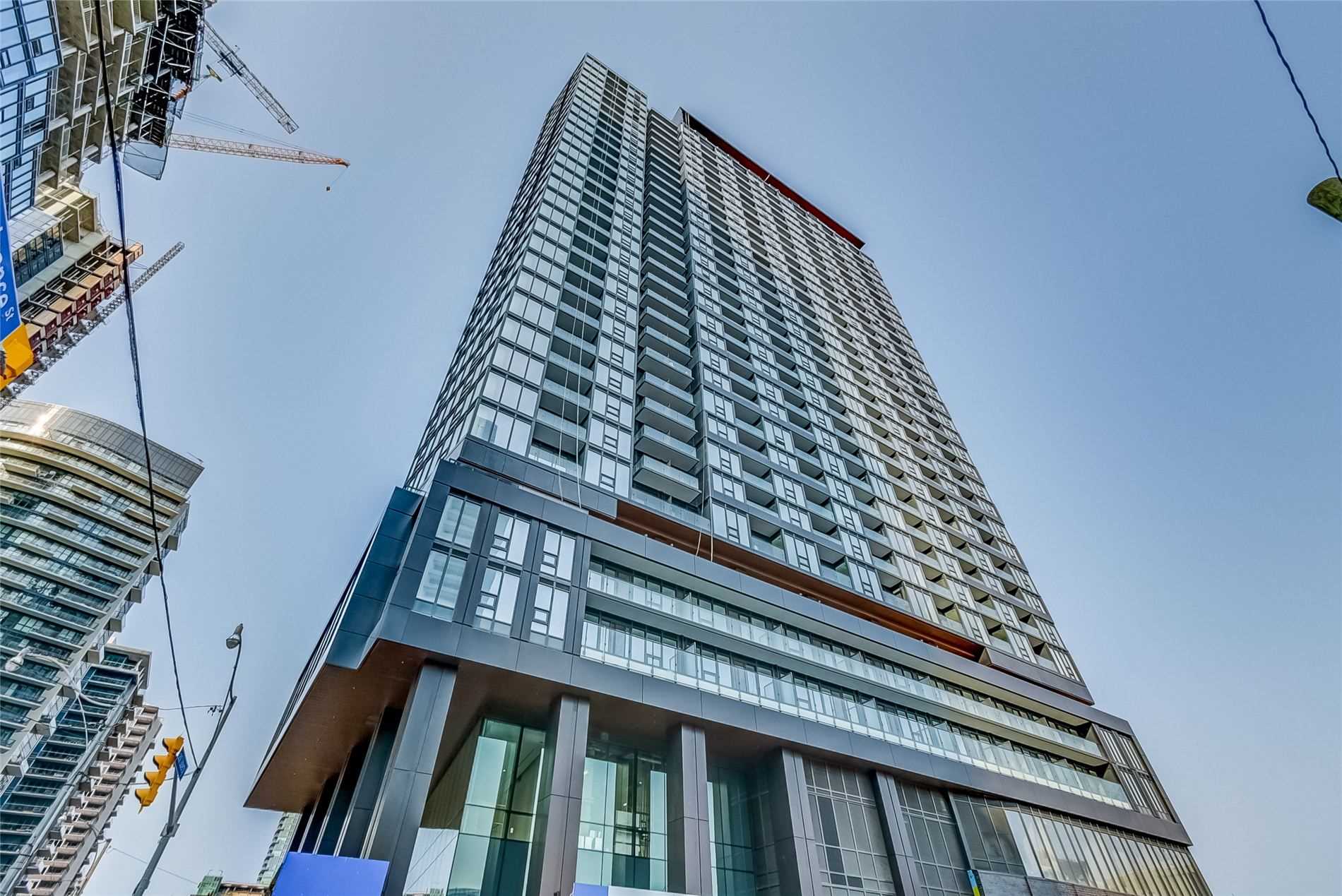 Low angle view of Zen Condo's gray lines, blue glass and geometric design.