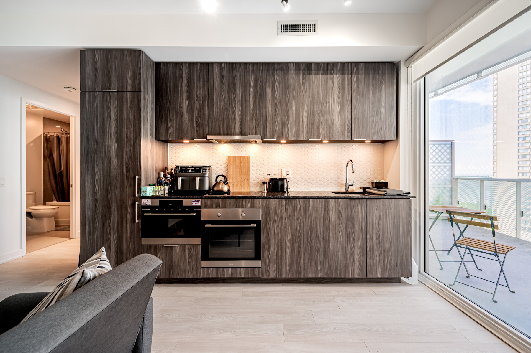 15 Queens Quay E Unit 1405 kitchen with dark cabinets and counters.