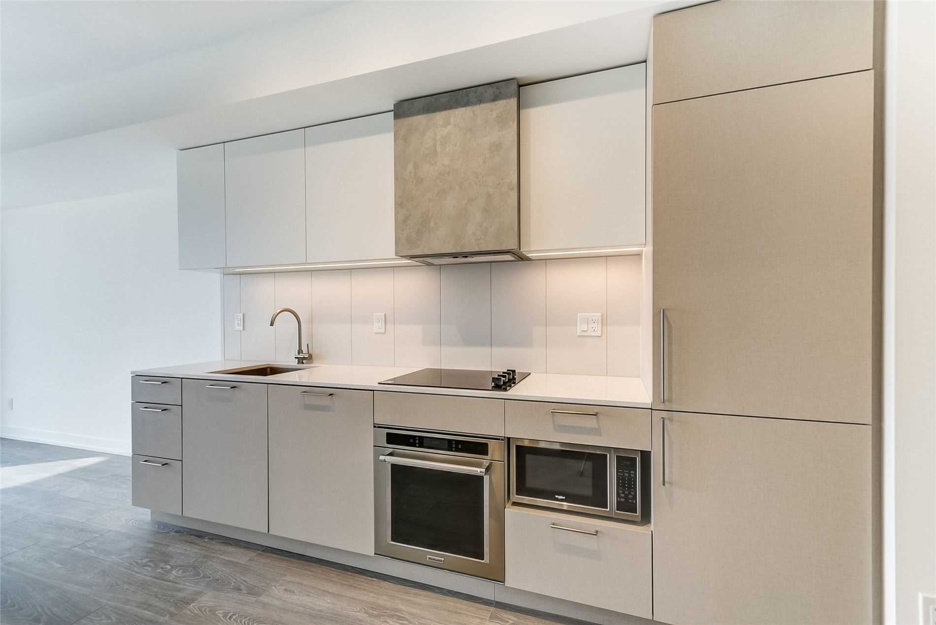 Large kitchen cabinets with darker colours.