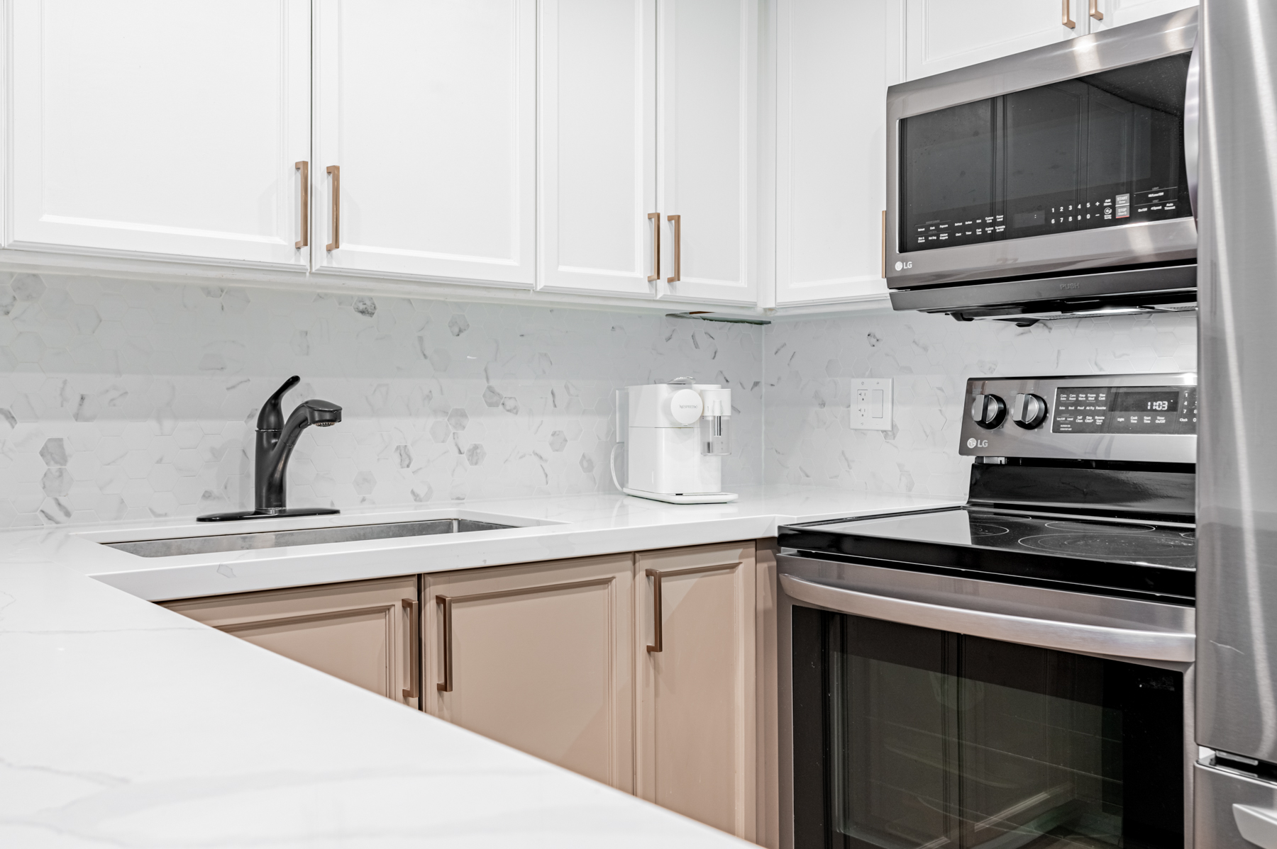 White quartz counters in condo kitchen.