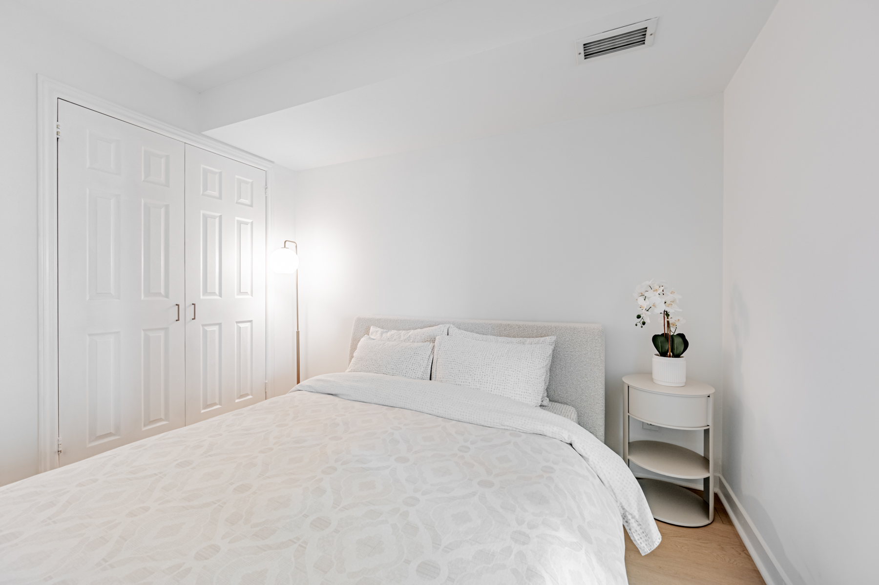 Condo bedroom with large double door closet.