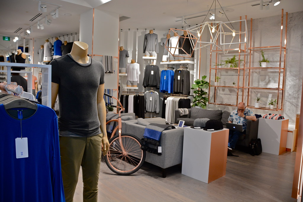 High end clothing boutique in Yorkville with male mannequin, bicycle and chic décor. 