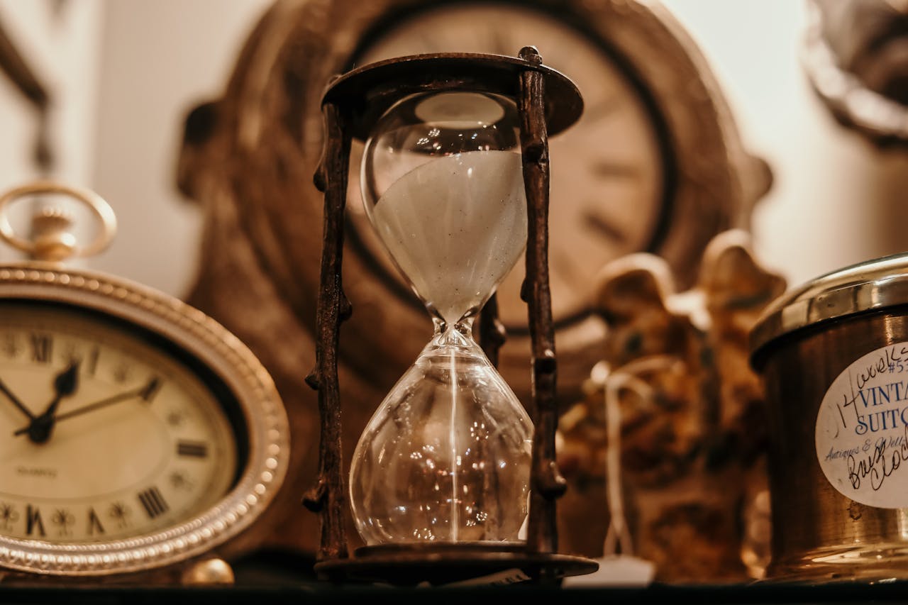 Photo of antique clocks and hourglass. 