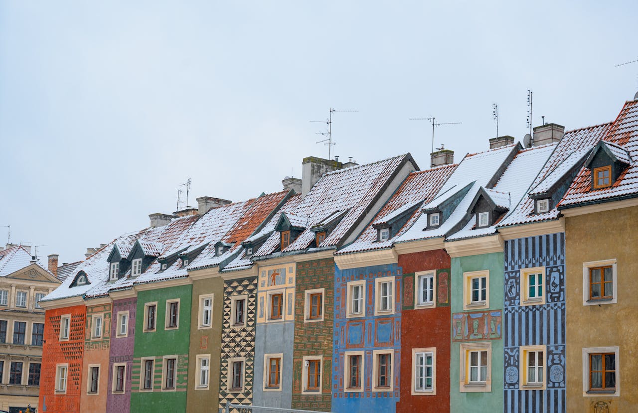 Row houses in winter with snow on roofs.