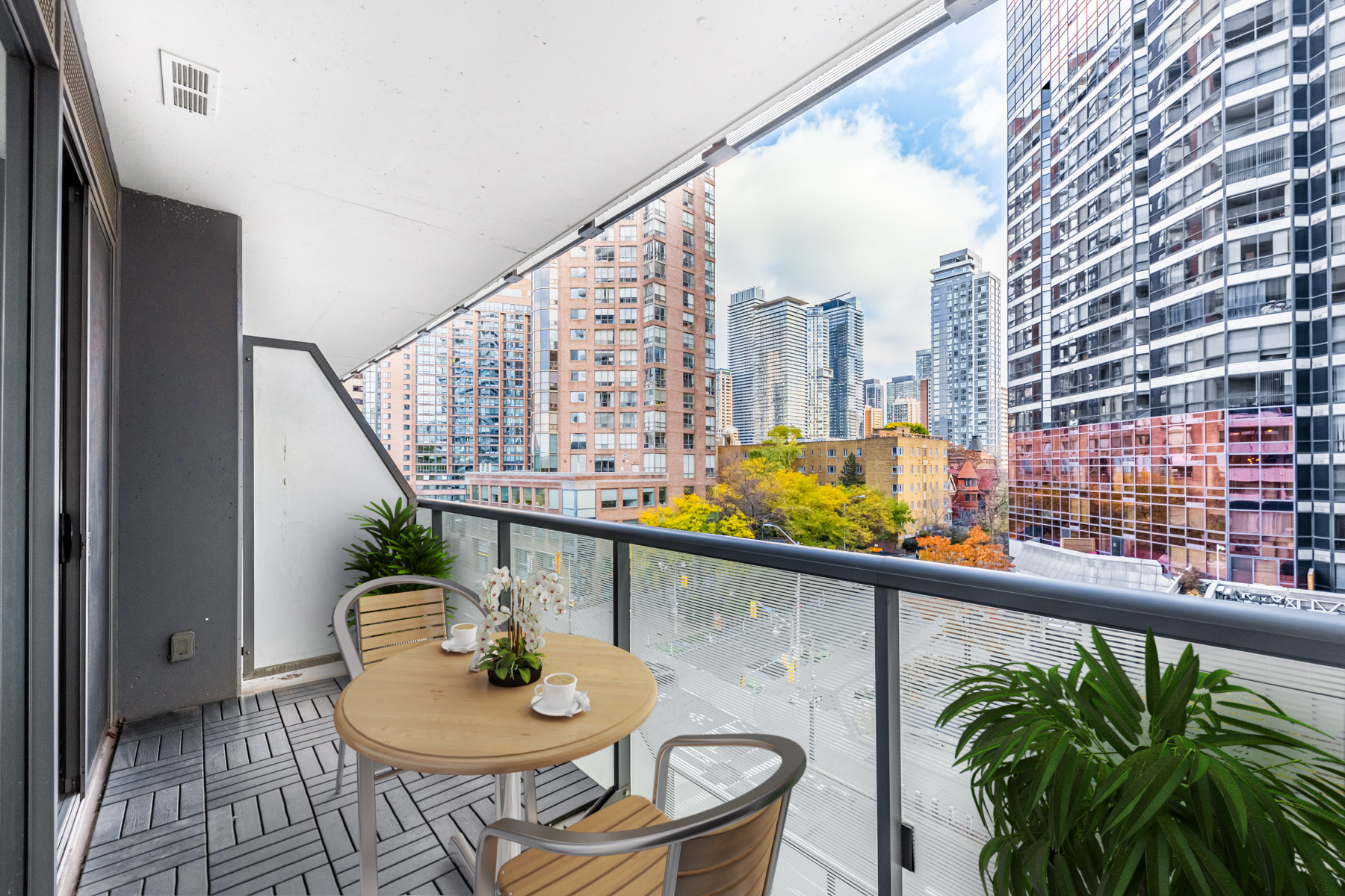 57 St Joseph Street Unit 523 balcony with 3D-rendered patio furniture and glazed divider.