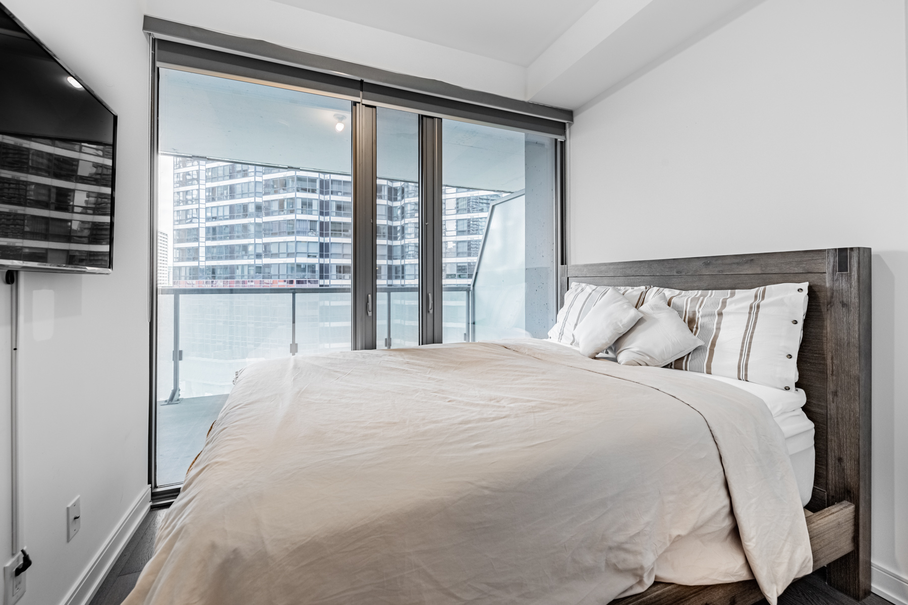 57 St Joseph Street Unit 523 – primary bedroom with walk-out balcony.