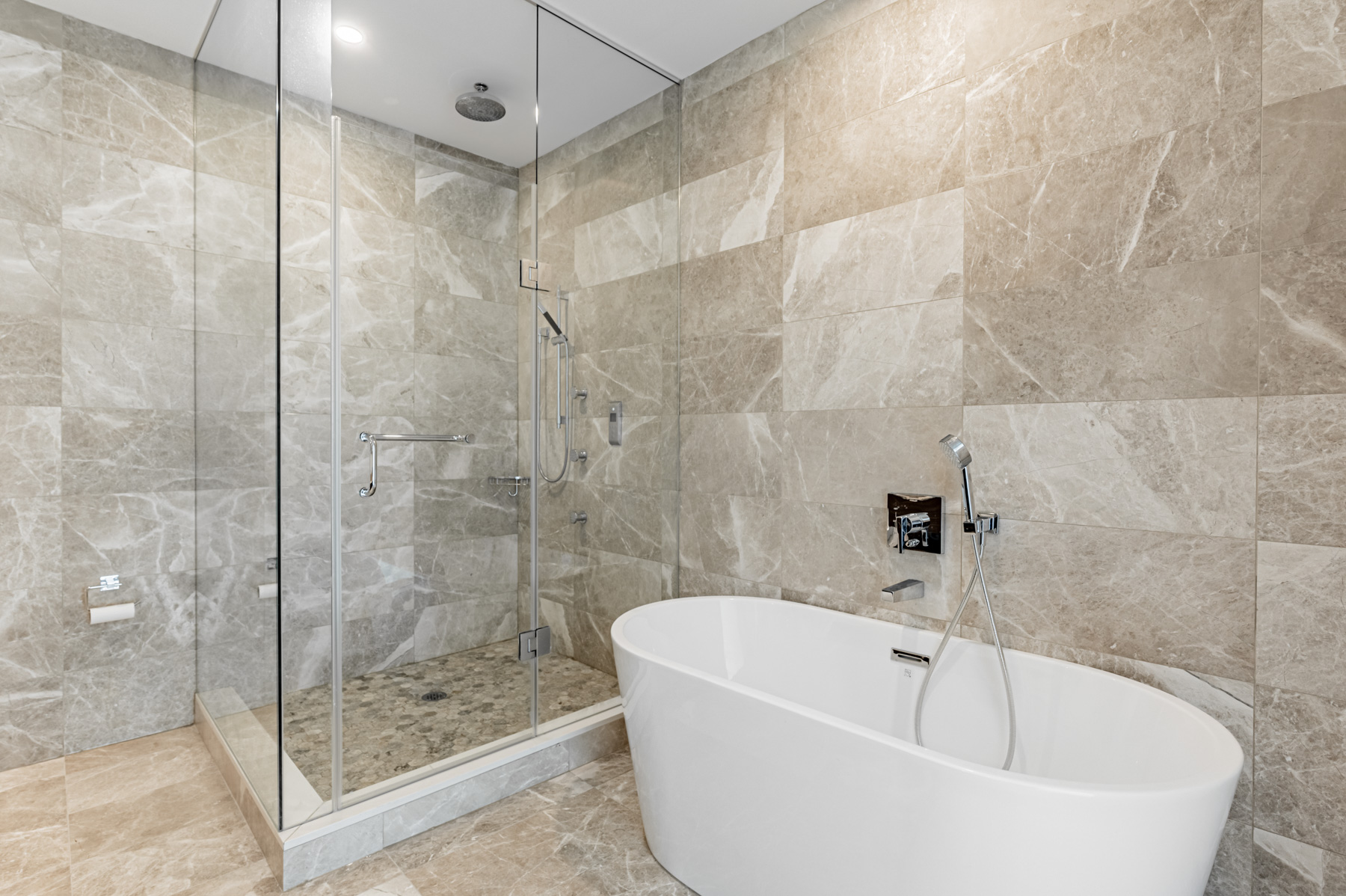 488 University Ave Suite 5408 ensuite bath with frameless glass shower and white soaker tub.