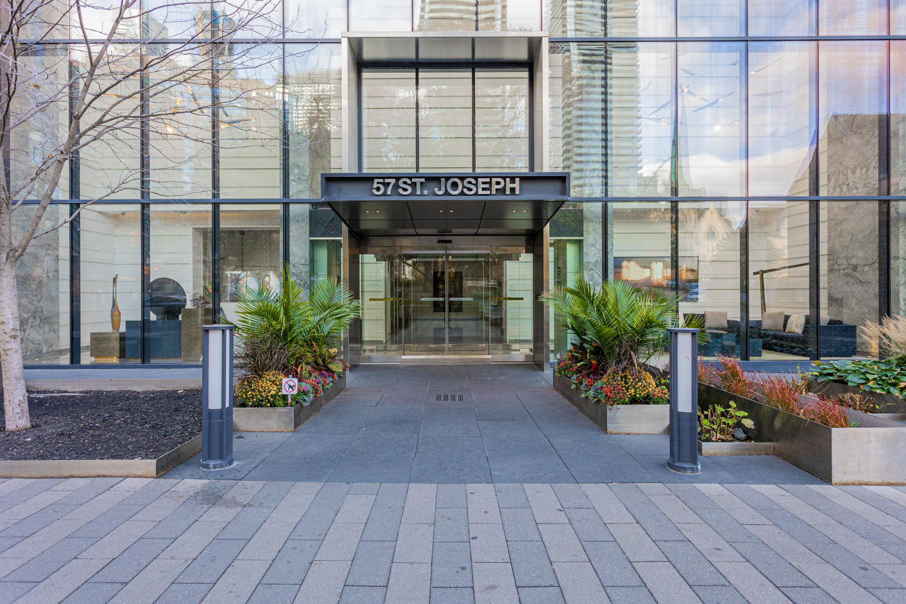 Glassy condo entrance with address on top.