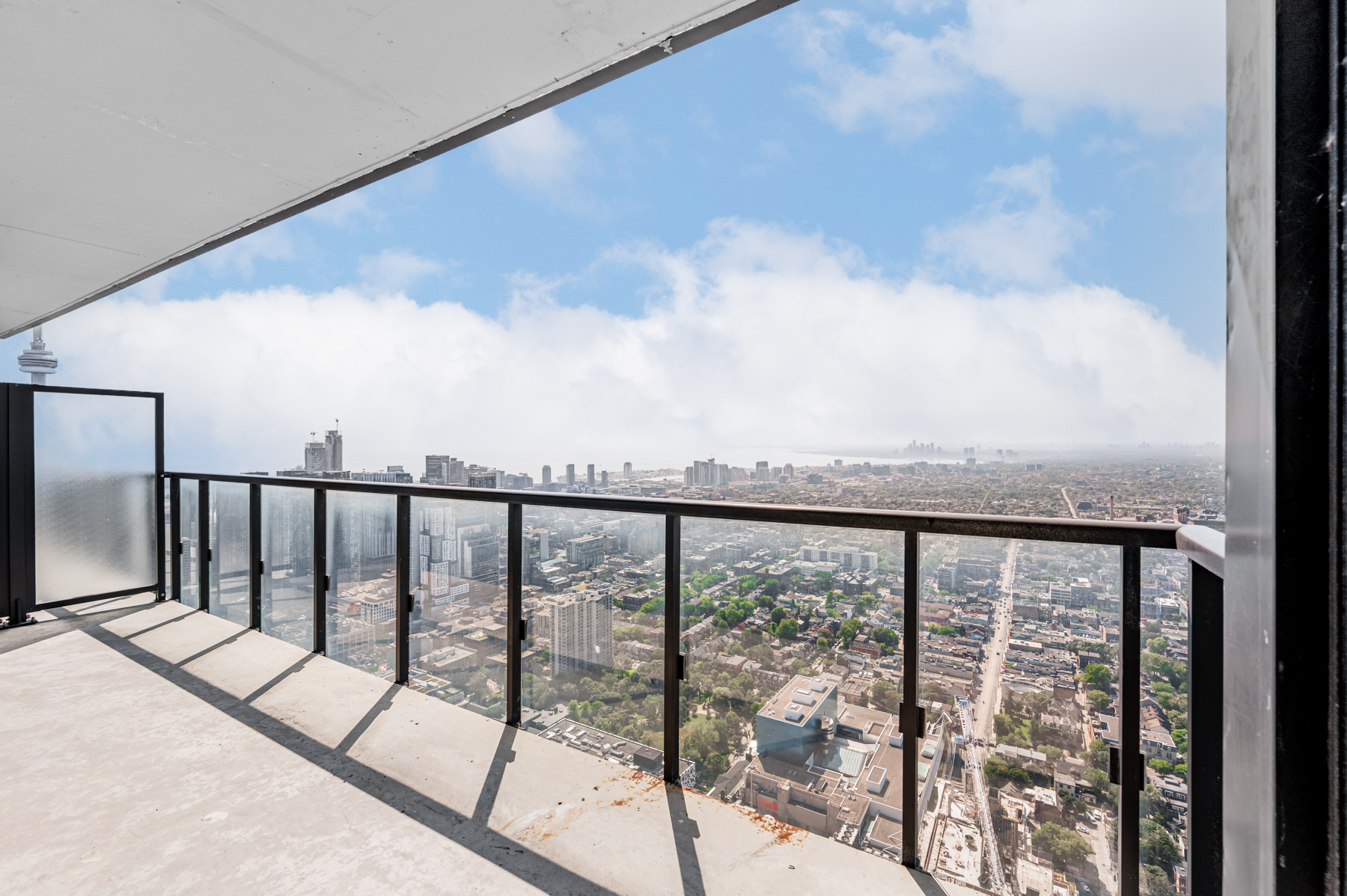 Condo balcony with clear glass panels.