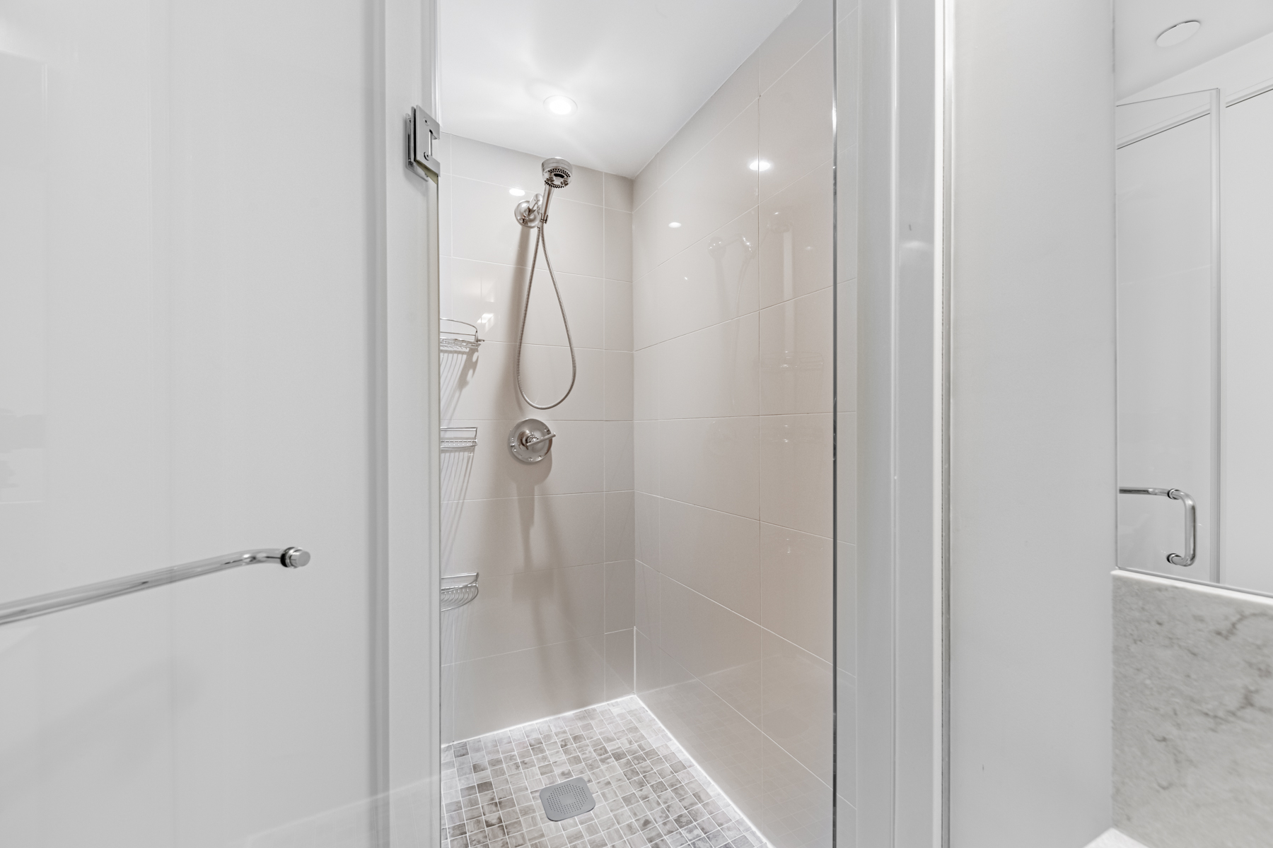 Condo bath with frame-glass walk-in shower.