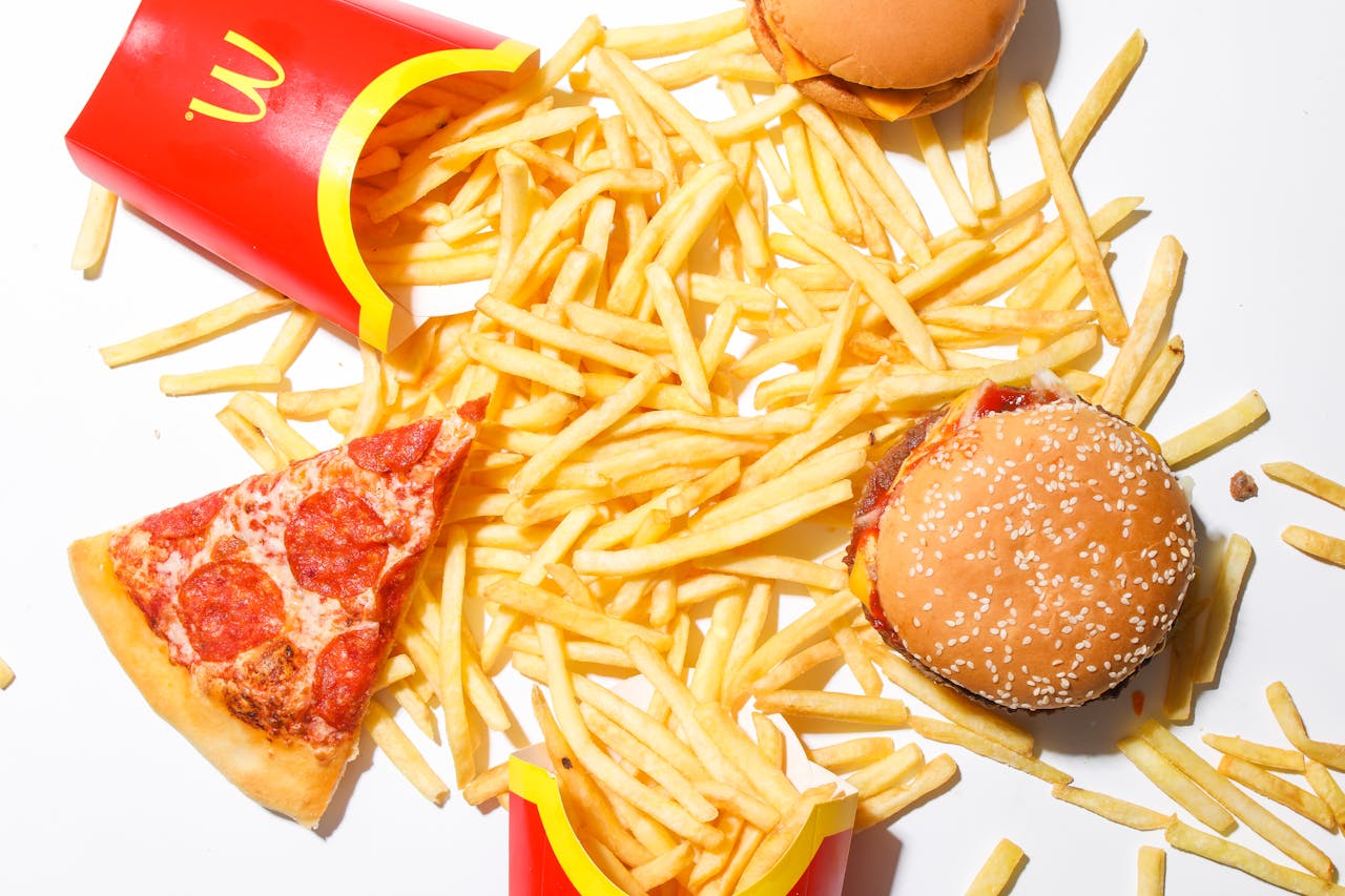 Image of McDonald's food, including fries, burger and pizza. 