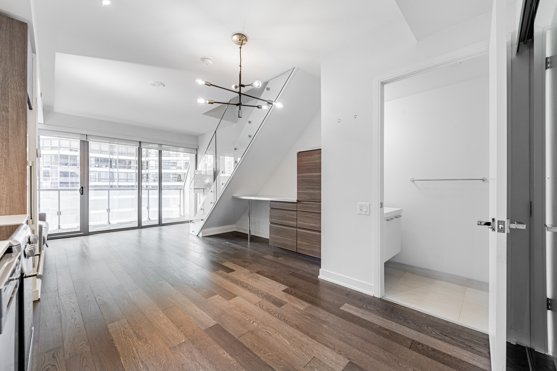 57 St Joseph Street Unit 523 living room, dining room and kitchen with stairs.