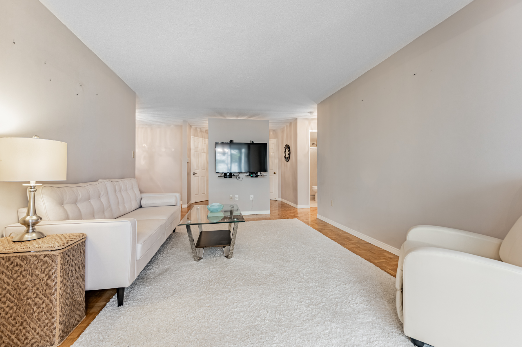 Large condo living room with gray furniture – 280 Simcoe St Unit 308A.