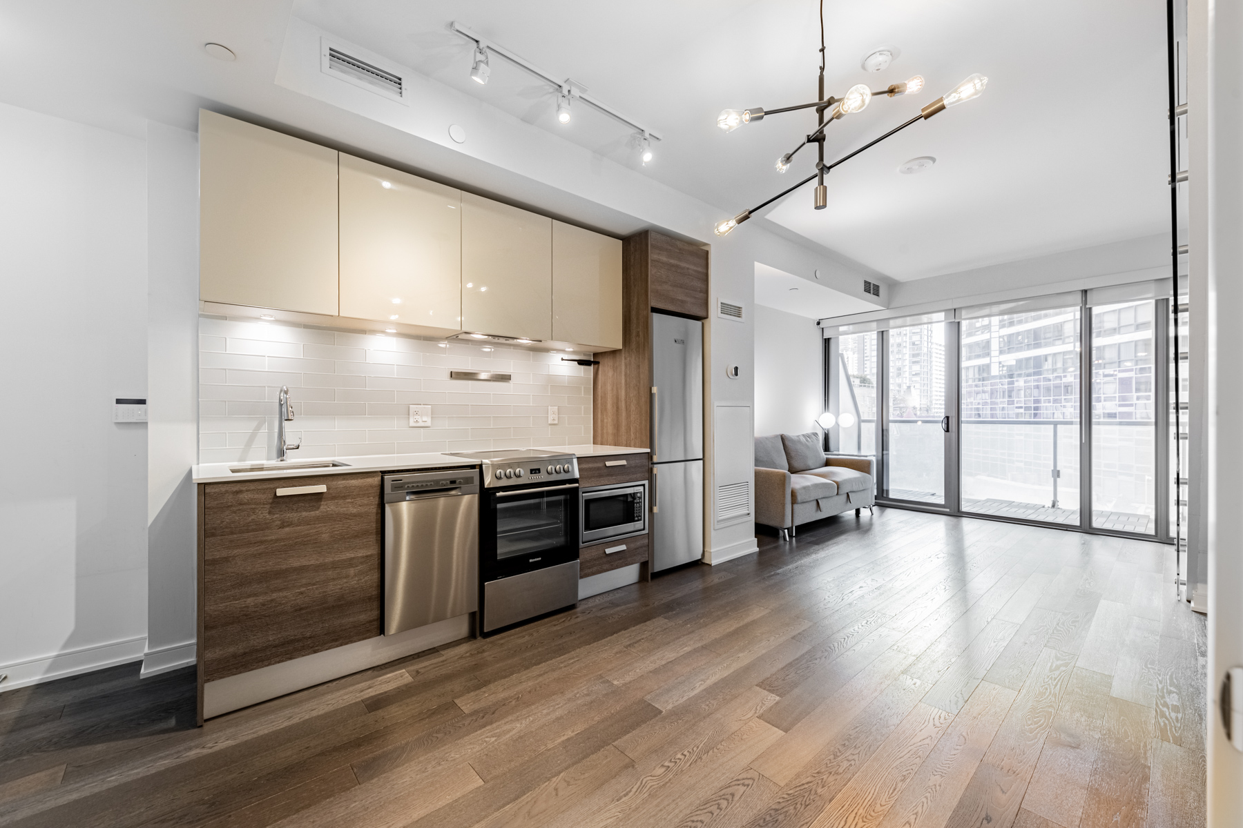 57 St Joseph Street Unit 523 kitchen and dining room lit by multiple light sources.