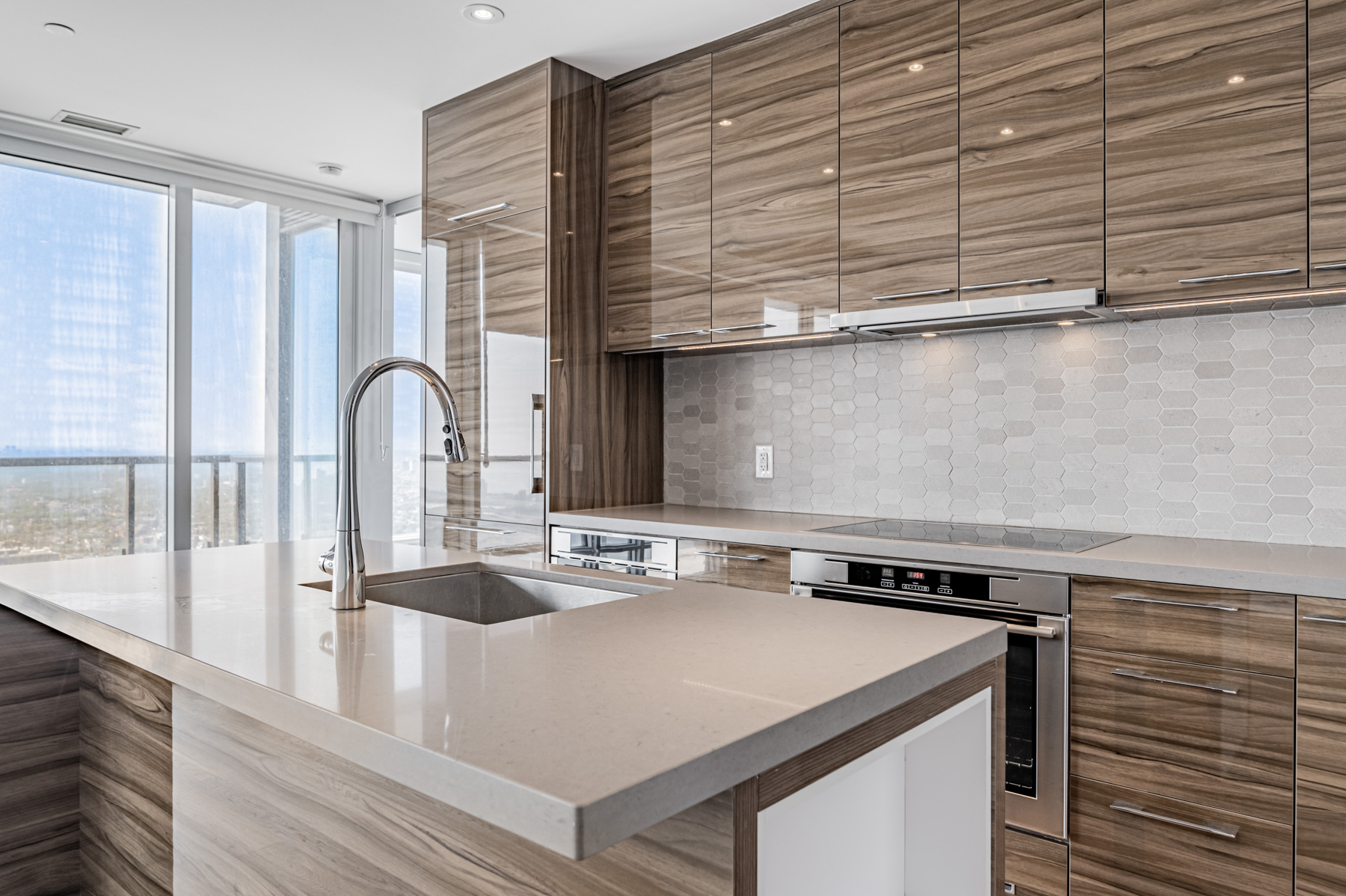 Close up of condo gleaming brown kitchen cabinets.