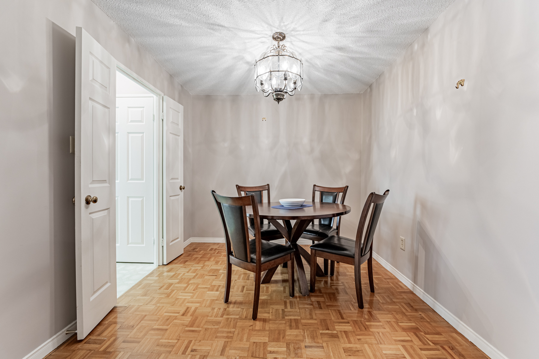 280 Simcoe St Unit 308A separate dining room with round table and chairs. 