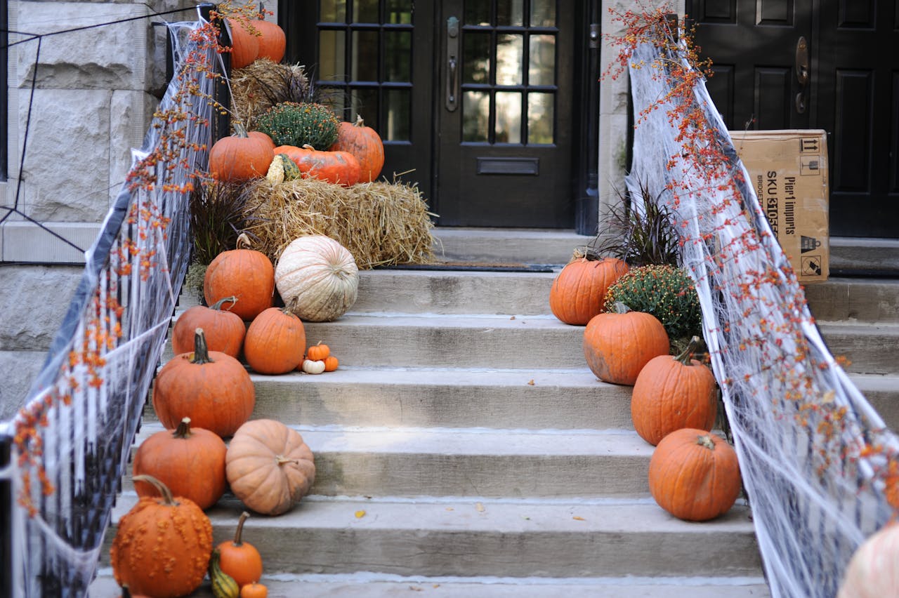 Halloween decorations including pumpkins outside house to show October 2024 housing market.