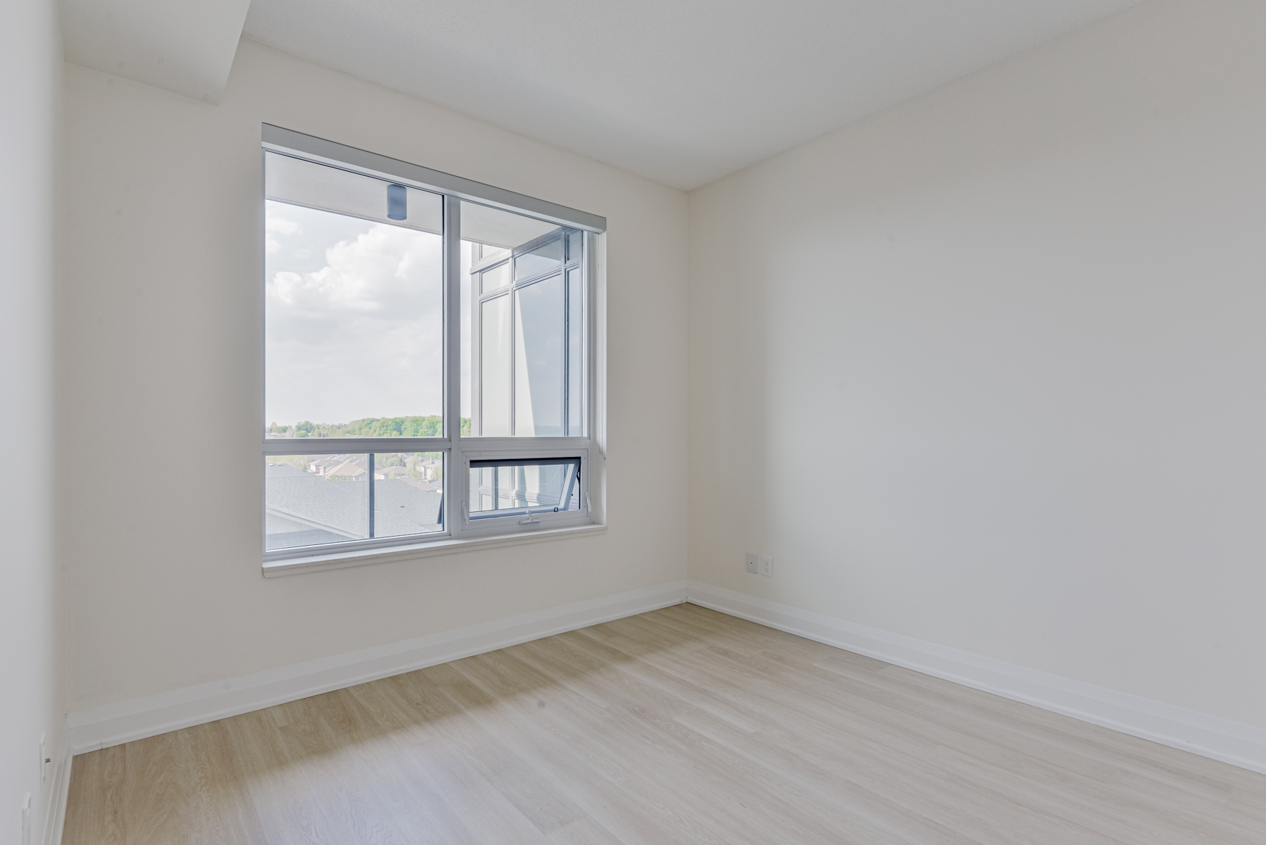 398 Highway 7 Rd E Unit 601 primary bedroom with view of ravine through window.