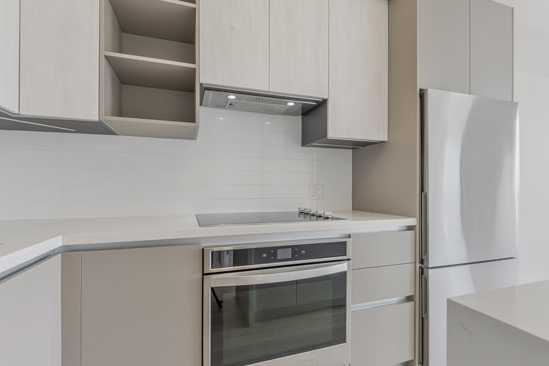 Condo back-splash with white ceramic subway tiles.