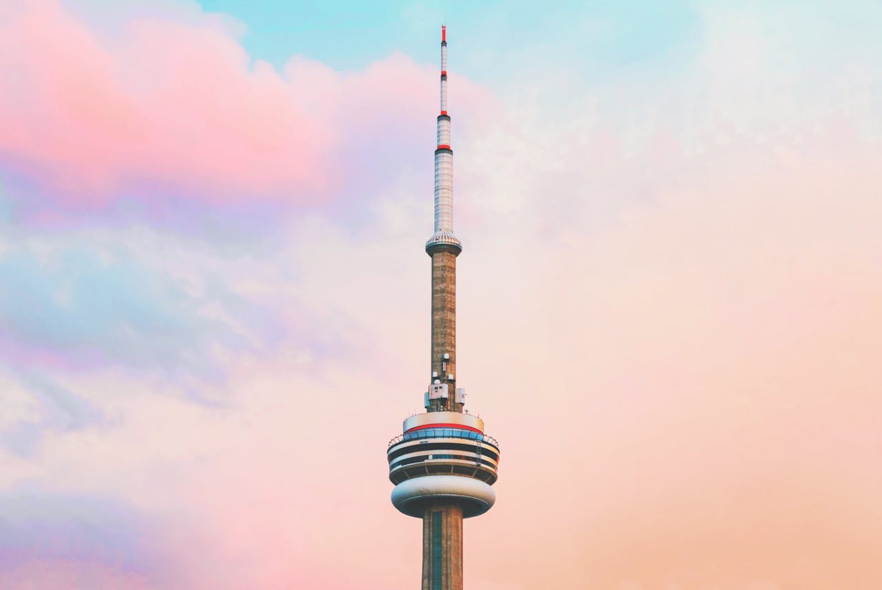 Close up CN Tower against colourful sky to show optimism for housing market. 