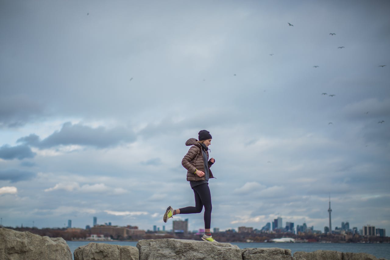 Woman jogging with Toronto skyline background to show strong November 2024 GTA housing market. 