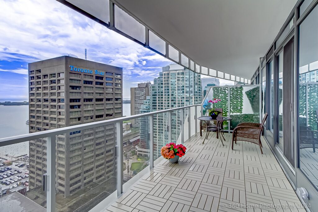 28 Freeland St Unit 2401 large balcony with tiled floors and view of Toronto Star building.