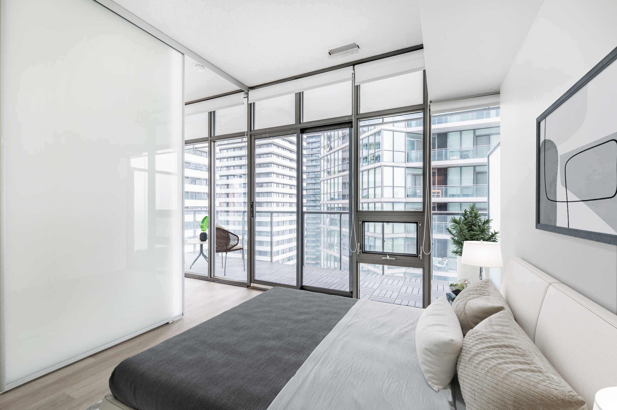 Primary bedroom with sliding door and floor-to-ceiling windows – 33 Charles St E Unit 3808.