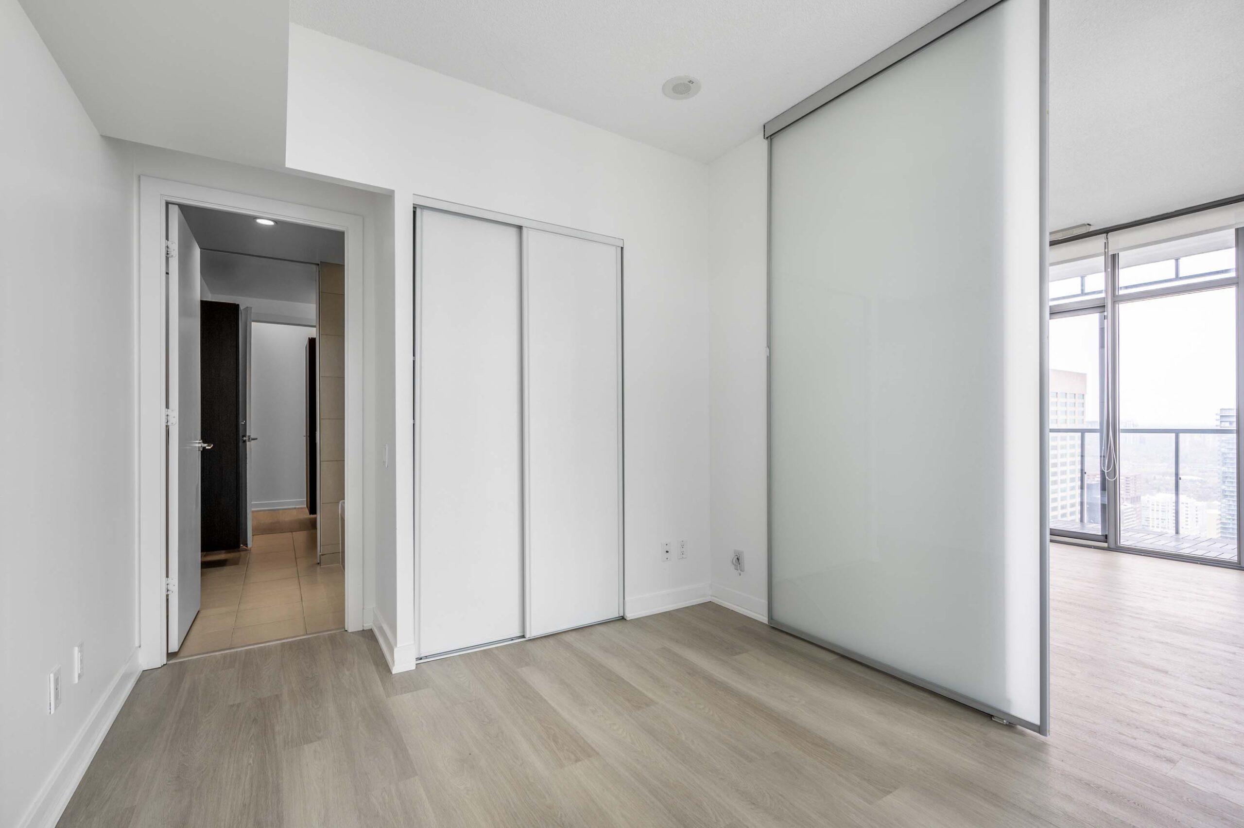 Condo bedroom with semi-ensuite bath.