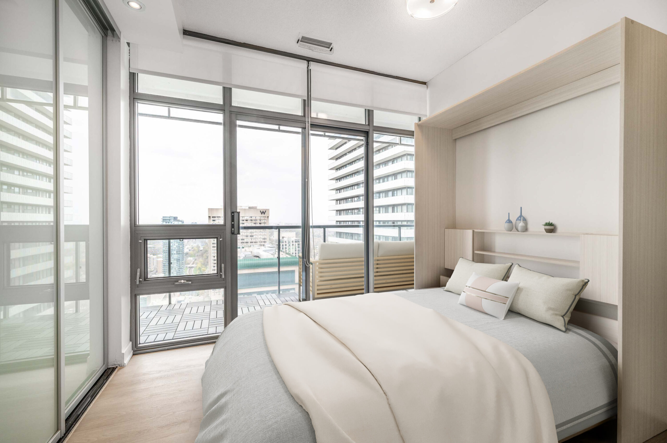 33 Charles St E Unit 3808 spacious second bedroom with large floor-to-ceiling windows.