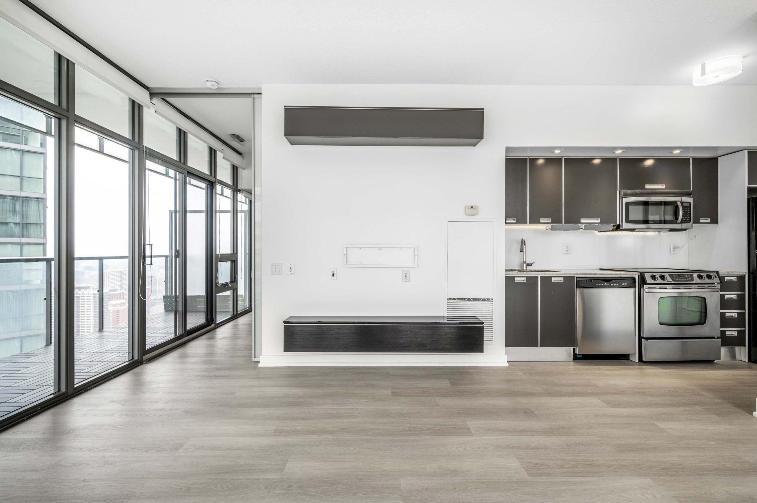Condo living and dining areas with new wide-plank vinyl floors – 33 Charles St E Unit 3808.