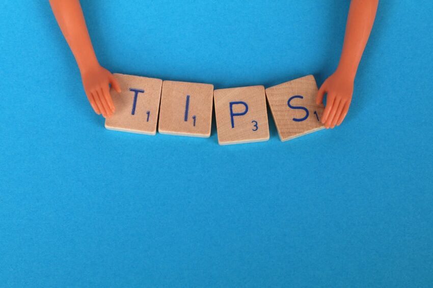 Image of large wooden tiles spelling “TIPS” for advice on buying resale property section.
