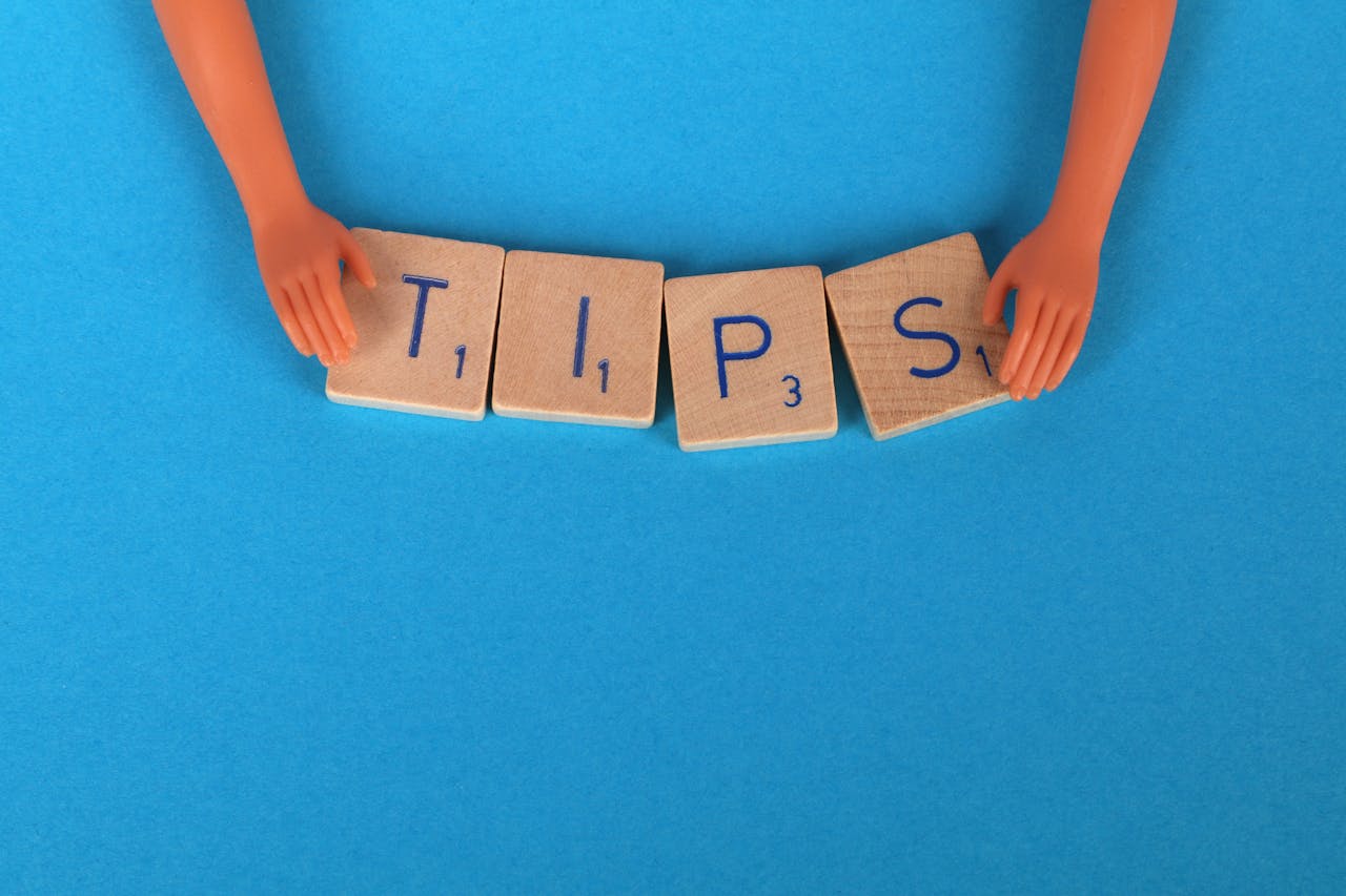 Image of large wooden tiles spelling “TIPS” for advice on buying resale property section.