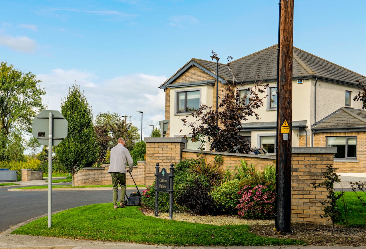 Man mowing lawn to show importance of curb appeal.