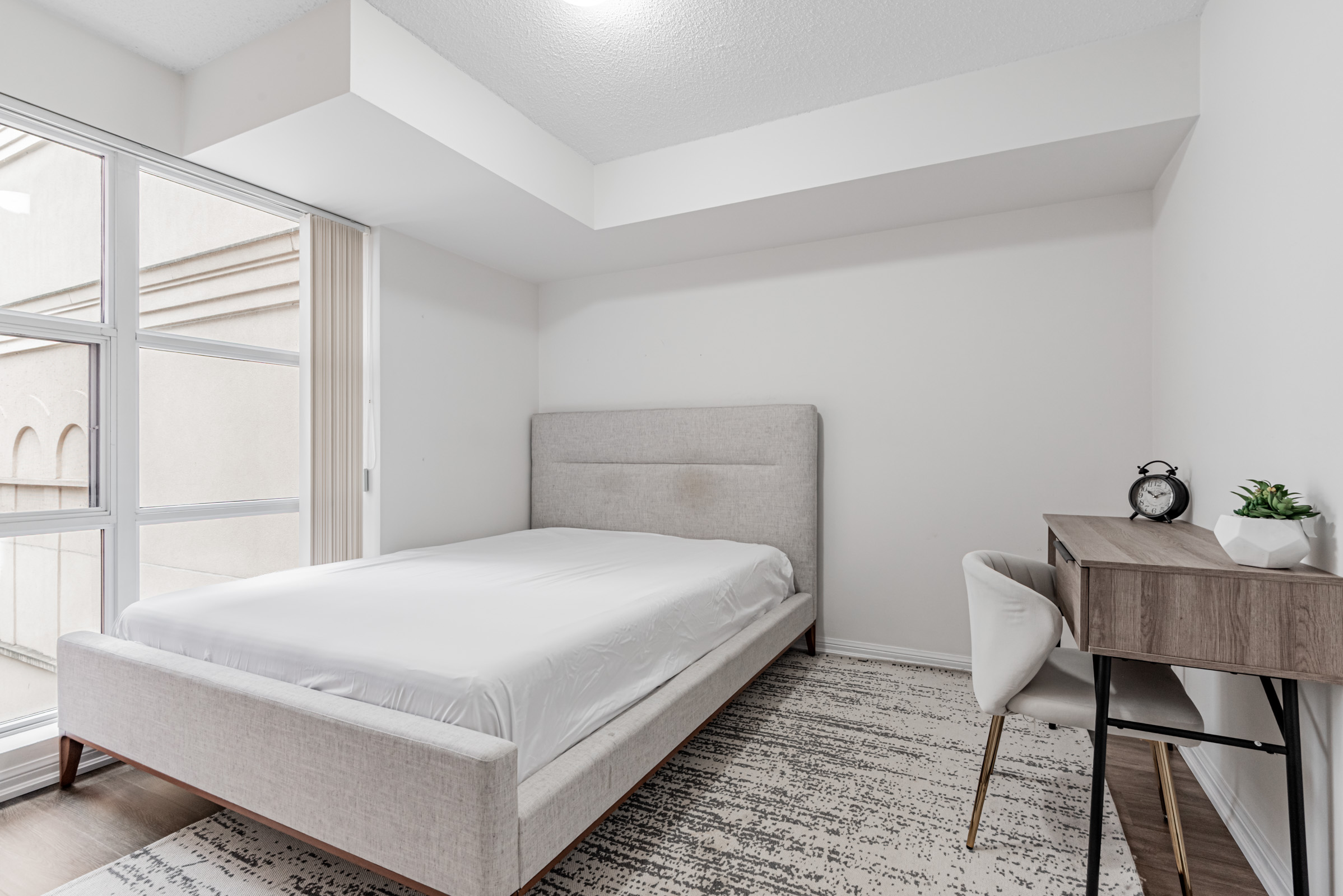 Condo bedroom with work desk and chair. 